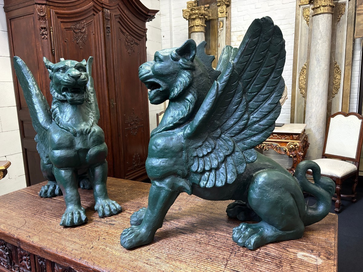 Pair of large, 20th-century cast iron, Empire-style mythological winged lions Highly decorative sculptures for gardens or interiors, with the following dimensions: Height: 83 cm Width: 47 cm Length: 89 cm