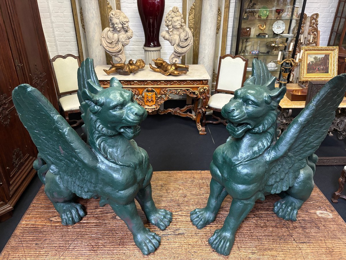 Pair of large, 20th-century cast iron, Empire-style mythological winged lions Highly decorative sculptures for gardens or interiors, with the following dimensions: Height: 83 cm Width: 47 cm Length: 89 cm