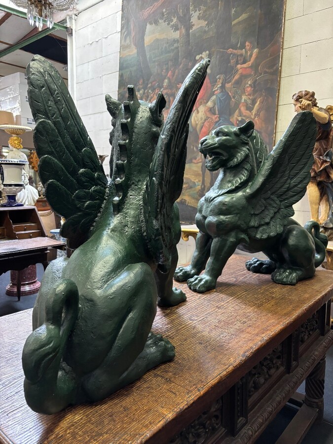 Pair of large, 20th-century cast iron, Empire-style mythological winged lions Highly decorative sculptures for gardens or interiors, with the following dimensions: Height: 83 cm Width: 47 cm Length: 89 cm