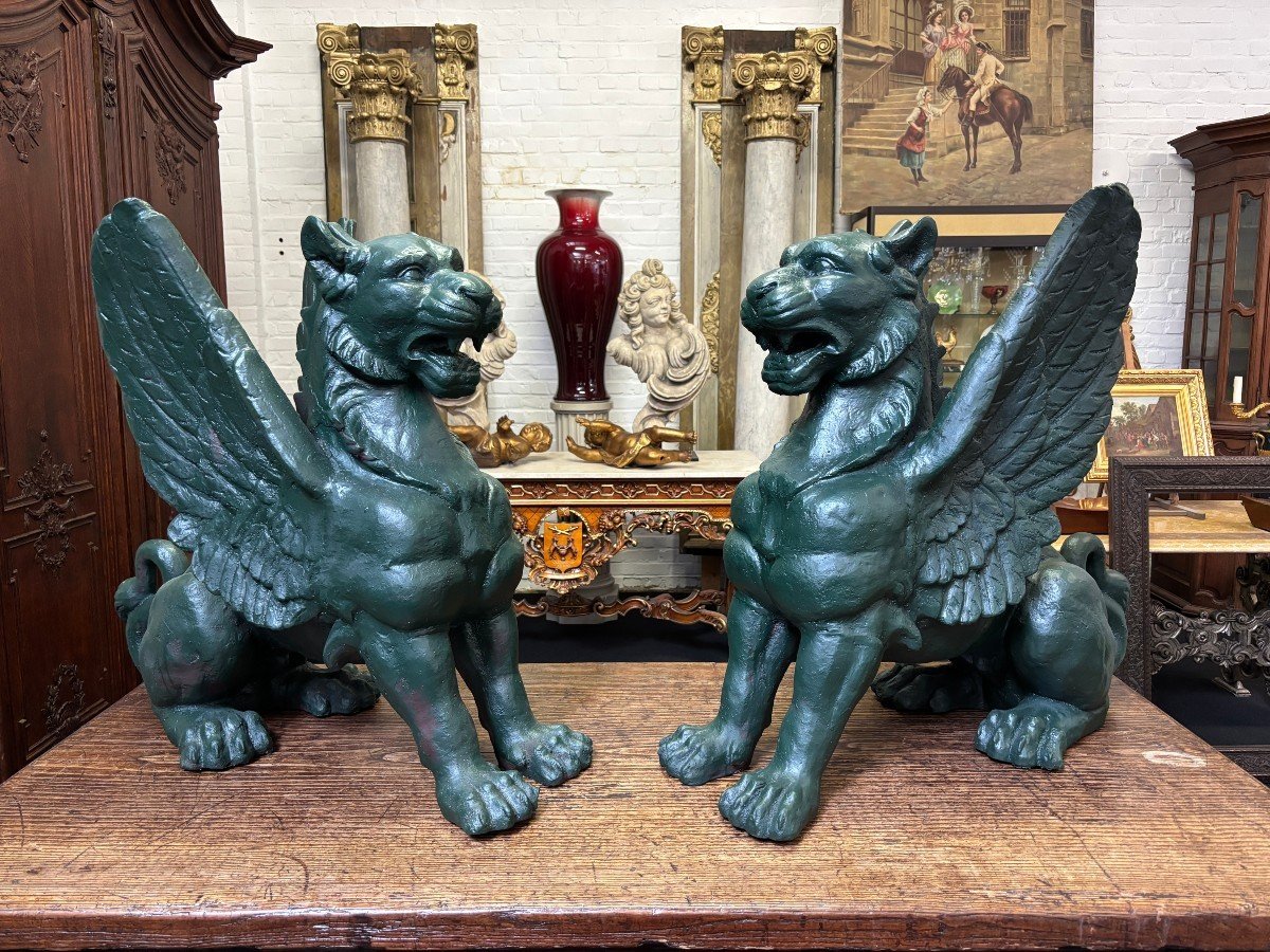 Pair of large, 20th-century cast iron, Empire-style mythological winged lions Highly decorative sculptures for gardens or interiors, with the following dimensions: Height: 83 cm Width: 47 cm Length: 89 cm