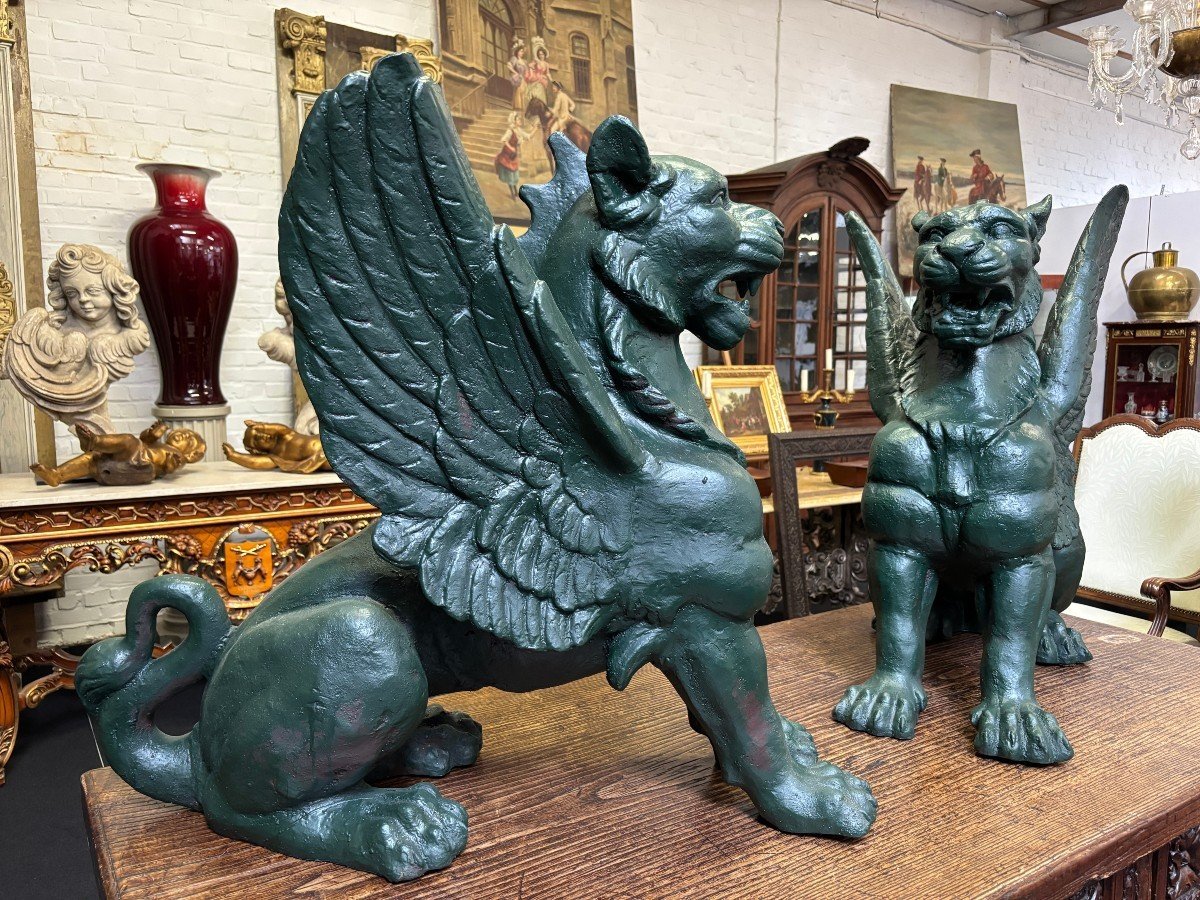 Pair of large, 20th-century cast iron, Empire-style mythological winged lions Highly decorative sculptures for gardens or interiors, with the following dimensions: Height: 83 cm Width: 47 cm Length: 89 cm
