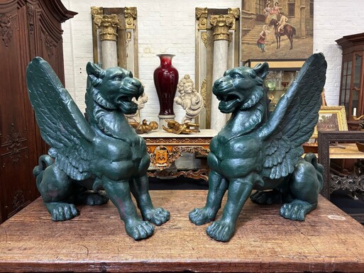 Pair of large, 20th-century cast iron, Empire-style mythological winged lions Highly decorative sculptures for gardens or interiors, with the following dimensions: Height: 83 cm Width: 47 cm Length: 89 cm
