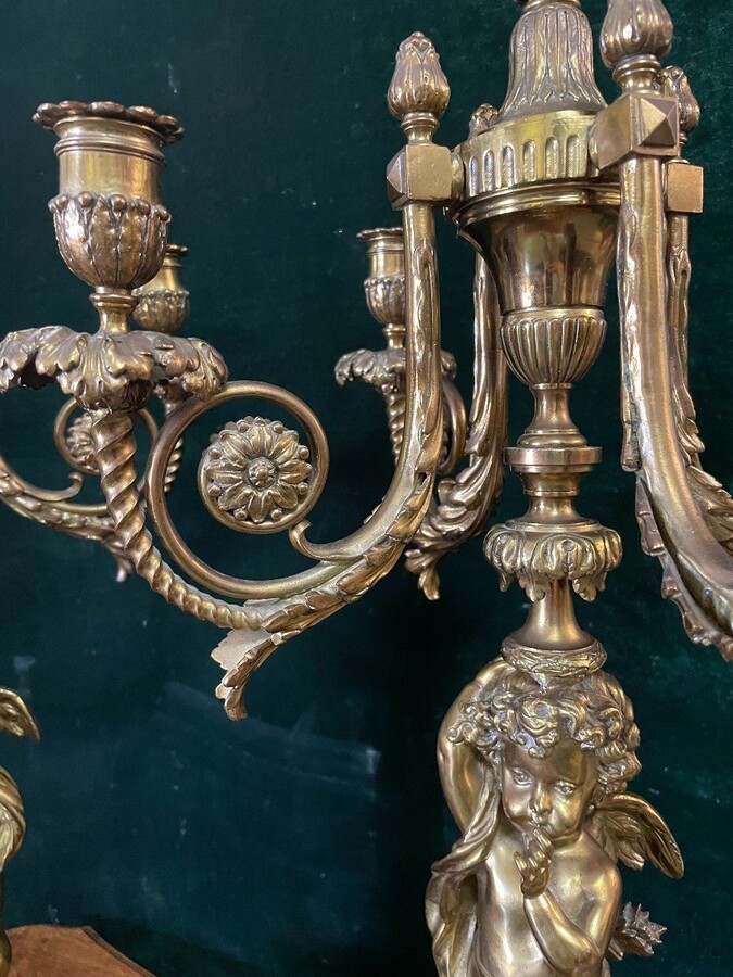 Pair of large candelabras with angels in 19th century bronze. Large Louis XVI style candelabra with 4 candlesticks. Dimensions: Height : 76 cm Width : 30 cm Depth : 32 cm Base: 16.5 x 16.5 cm Pair of large candelabras with angels in 19th century bronze.