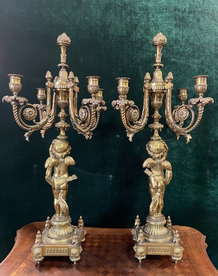 Pair of large candelabras with angels in 19th century bronze. Large Louis XVI style candelabra with 4 candlesticks. Dimensions: Height : 76 cm Width : 30 cm Depth : 32 cm Base: 16.5 x 16.5 cm Pair of large candelabras with angels in 19th century bronze.