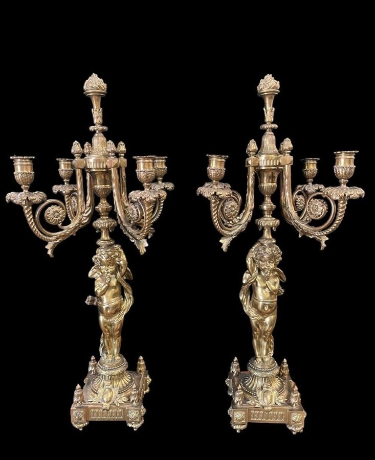 Pair of large candelabras with angels in 19th century bronze. Large Louis XVI style candelabra with 4 candlesticks. Dimensions: Height : 76 cm Width : 30 cm Depth : 32 cm Base: 16.5 x 16.5 cm Pair of large candelabras with angels in 19th century bronze.
