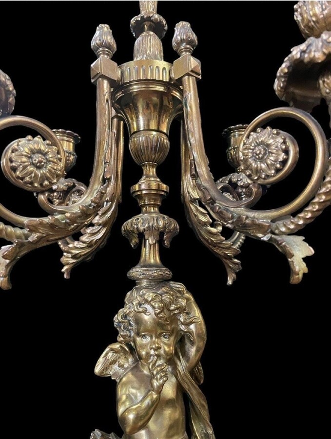 Pair of large candelabras with angels in 19th century bronze. Large Louis XVI style candelabra with 4 candlesticks. Dimensions: Height : 76 cm Width : 30 cm Depth : 32 cm Base: 16.5 x 16.5 cm Pair of large candelabras with angels in 19th century bronze.