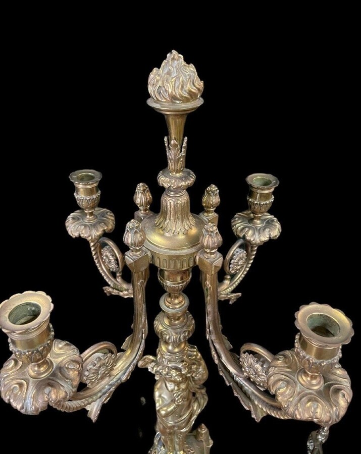 Pair of large candelabras with angels in 19th century bronze. Large Louis XVI style candelabra with 4 candlesticks. Dimensions: Height : 76 cm Width : 30 cm Depth : 32 cm Base: 16.5 x 16.5 cm Pair of large candelabras with angels in 19th century bronze.