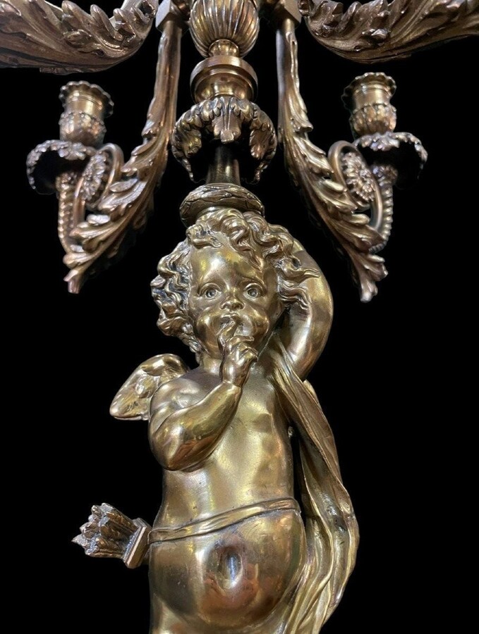 Pair of large candelabras with angels in 19th century bronze. Large Louis XVI style candelabra with 4 candlesticks. Dimensions: Height : 76 cm Width : 30 cm Depth : 32 cm Base: 16.5 x 16.5 cm Pair of large candelabras with angels in 19th century bronze.