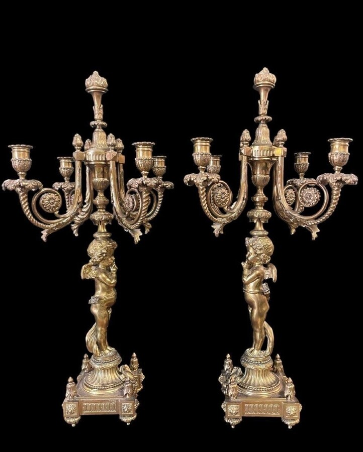 Pair of large candelabras with angels in 19th century bronze. Large Louis XVI style candelabra with 4 candlesticks. Dimensions: Height : 76 cm Width : 30 cm Depth : 32 cm Base: 16.5 x 16.5 cm Pair of large candelabras with angels in 19th century bronze.