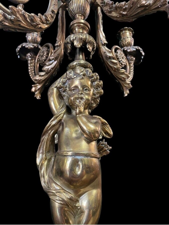 Pair of large candelabras with angels in 19th century bronze. Large Louis XVI style candelabra with 4 candlesticks. Dimensions: Height : 76 cm Width : 30 cm Depth : 32 cm Base: 16.5 x 16.5 cm Pair of large candelabras with angels in 19th century bronze.
