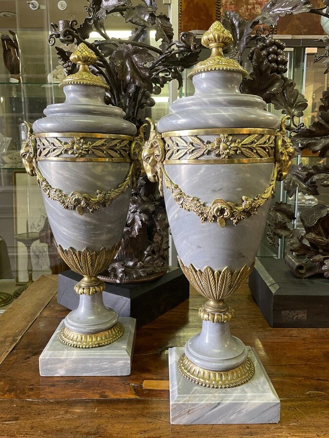 Pair of large casollettes in grey marble/bronze 19th century. Decorated with bronze girlandes , rams heads and ornaments. Both in very good condition Dimensions : Height : 52 cm Width : 21 cm Foot : 14 x 14 cm Decorative Casollettts from about 1860-1870