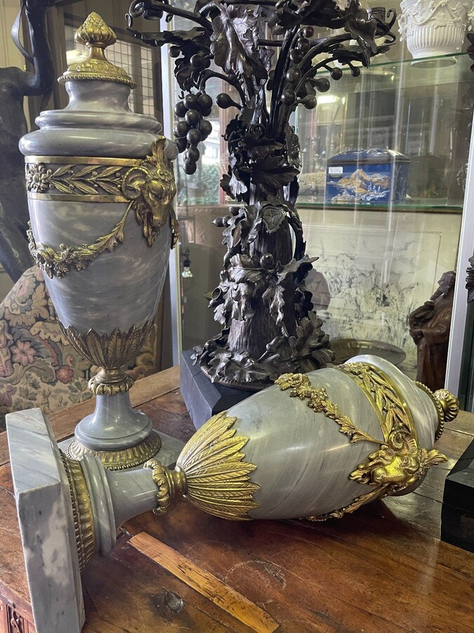 Pair of large casollettes in grey marble/bronze 19th century. Decorated with bronze girlandes , rams heads and ornaments. Both in very good condition Dimensions : Height : 52 cm Width : 21 cm Foot : 14 x 14 cm Decorative Casollettts from about 1860-1870