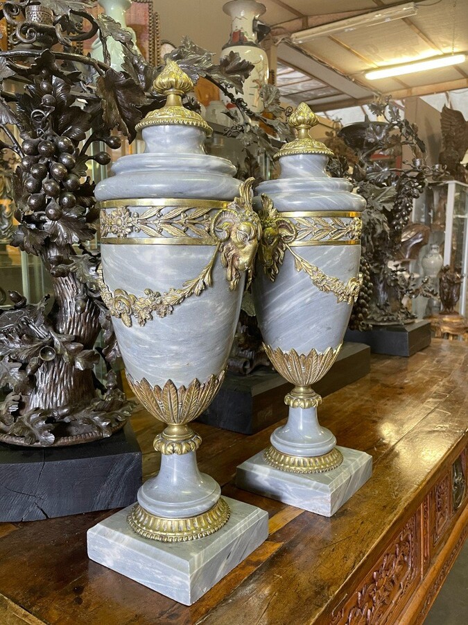 Pair of large casollettes in grey marble/bronze 19th century. Decorated with bronze girlandes , rams heads and ornaments. Both in very good condition Dimensions : Height : 52 cm Width : 21 cm Foot : 14 x 14 cm Decorative Casollettts from about 1860-1870