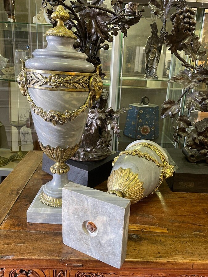 Pair of large casollettes in grey marble/bronze 19th century. Decorated with bronze girlandes , rams heads and ornaments. Both in very good condition Dimensions : Height : 52 cm Width : 21 cm Foot : 14 x 14 cm Decorative Casollettts from about 1860-1870