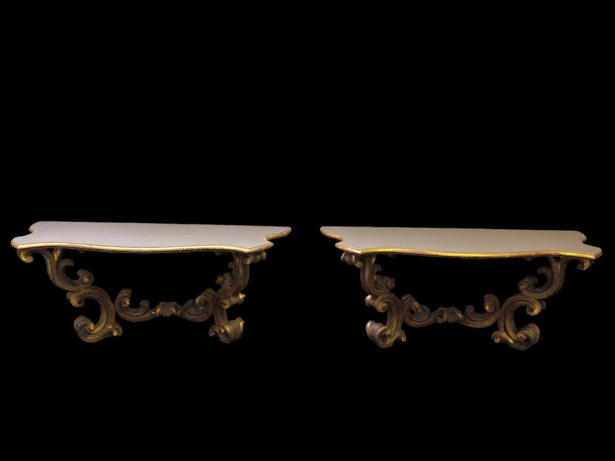 Pair of large consoles in gilt wood , Italian 18th century. Very decorative consoles decorated with large scrolls/ornaments in gilt wood with a painted top (tops in wood are recent , edge of table from the time). Dimensions : Width : 191 cm Height : 83,5