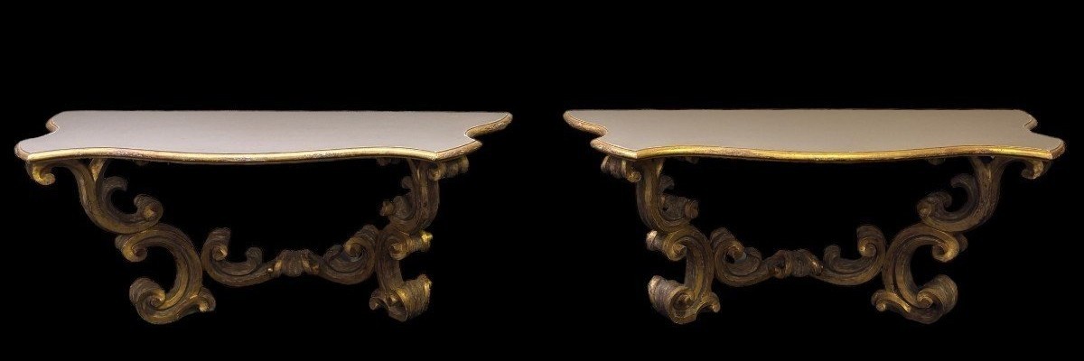 Pair of large consoles in gilt wood , Italian 18th century. Very decorative consoles decorated with large scrolls/ornaments in gilt wood with a painted top (tops in wood are recent , edge of table from the time). Dimensions : Width : 191 cm Height : 83,5