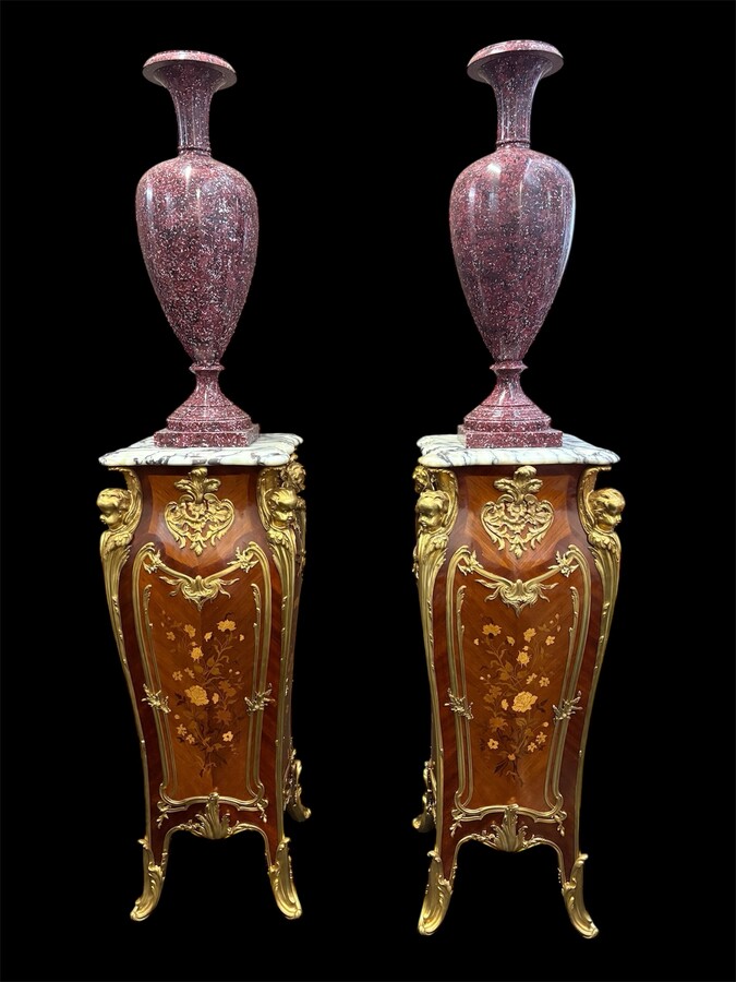 Pair of large Louis XV style marquetry/bronze columns, 20th century. High-quality columns adorned with fine marquetry and decorated with angels, ornaments and bronze feet, topped with magnificent marble. The columns are decorated all around.