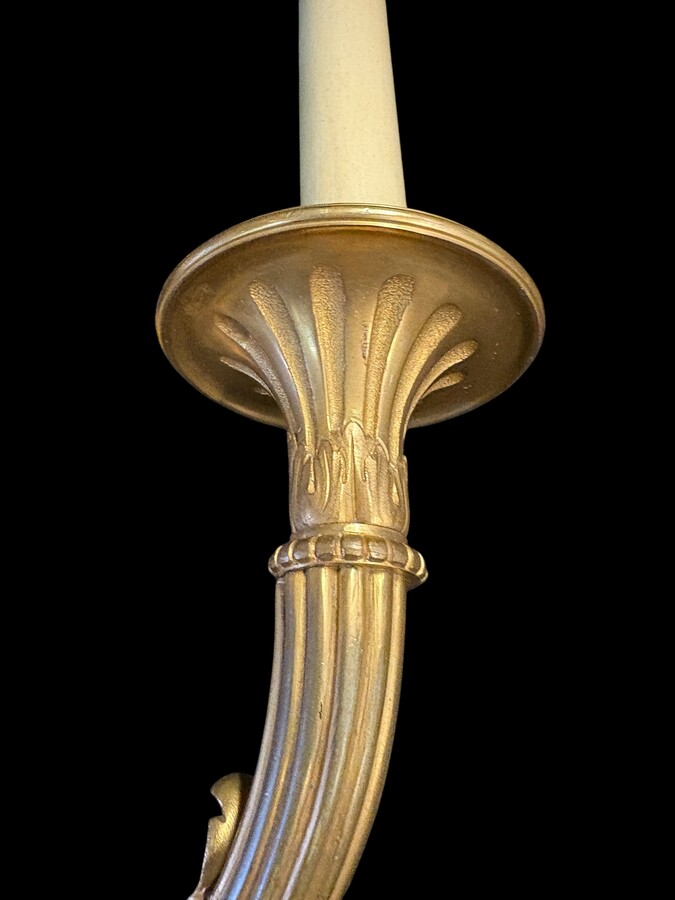 Pair of large Louis XVI-style bronze wall sconces, 19th century High-quality bronze wall sconces, chiselled, featuring an elegant design with two light points and a vase crowning the ensemble Dimensions: Height: 62 cm Width: 42 cm Depth: 22 cm