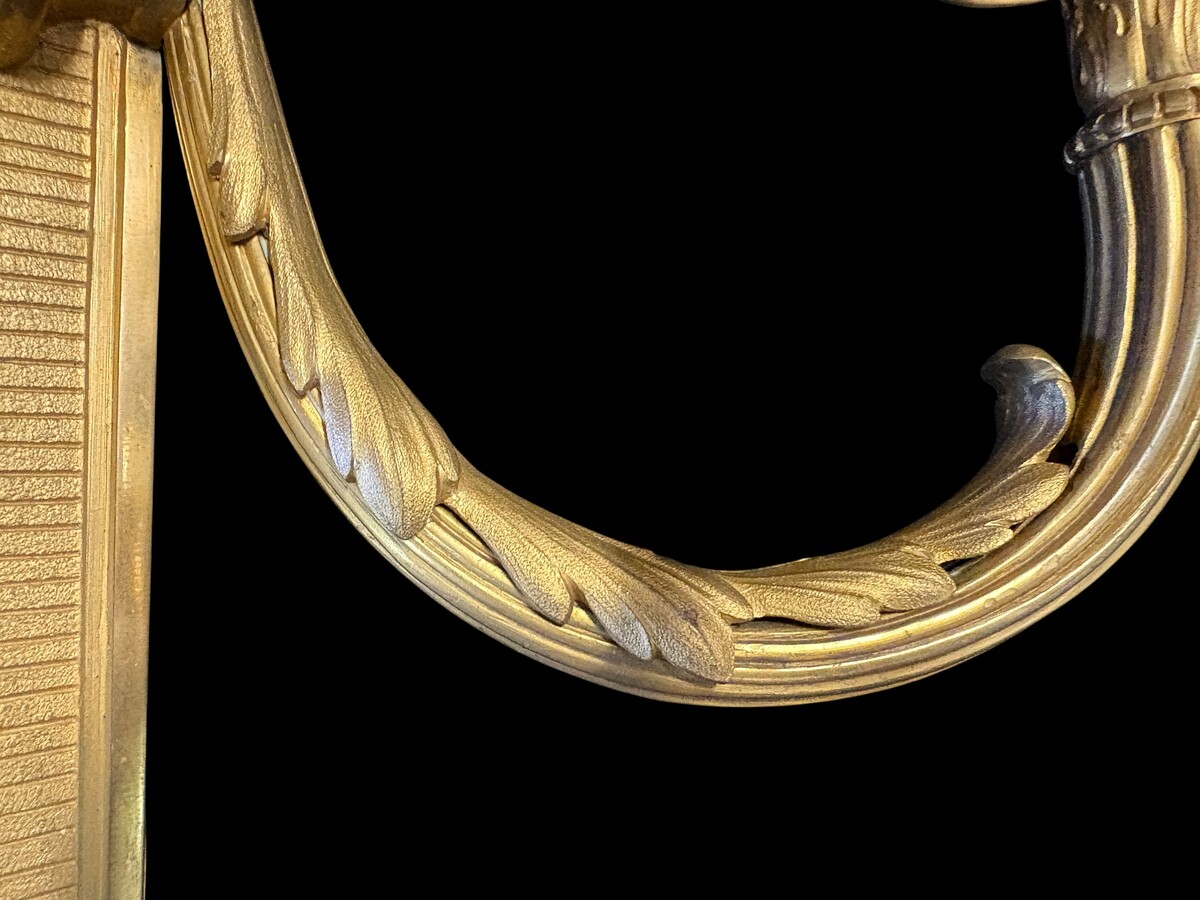 Pair of large Louis XVI-style bronze wall sconces, 19th century High-quality bronze wall sconces, chiselled, featuring an elegant design with two light points and a vase crowning the ensemble Dimensions: Height: 62 cm Width: 42 cm Depth: 22 cm