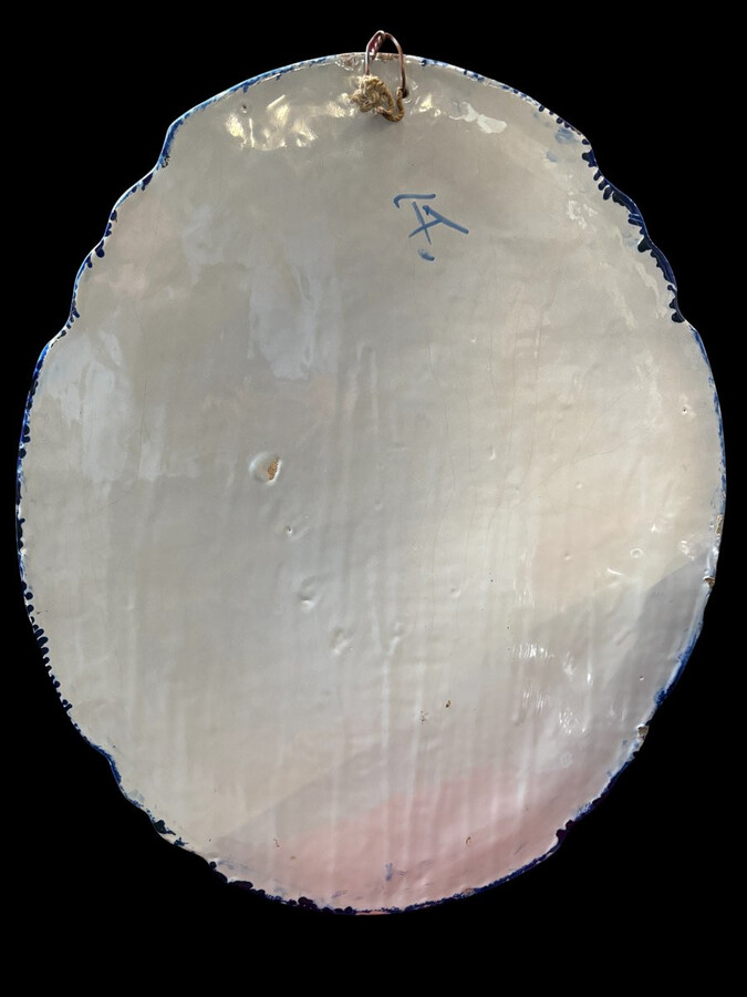 Pair of large Makkum earthenware wall plates Highly decorative blue and white earthenware wall plates depicting Dutch landscapes with windmills, water, boats, houses and animals. Fitted with a hanging loop and marked on the back.