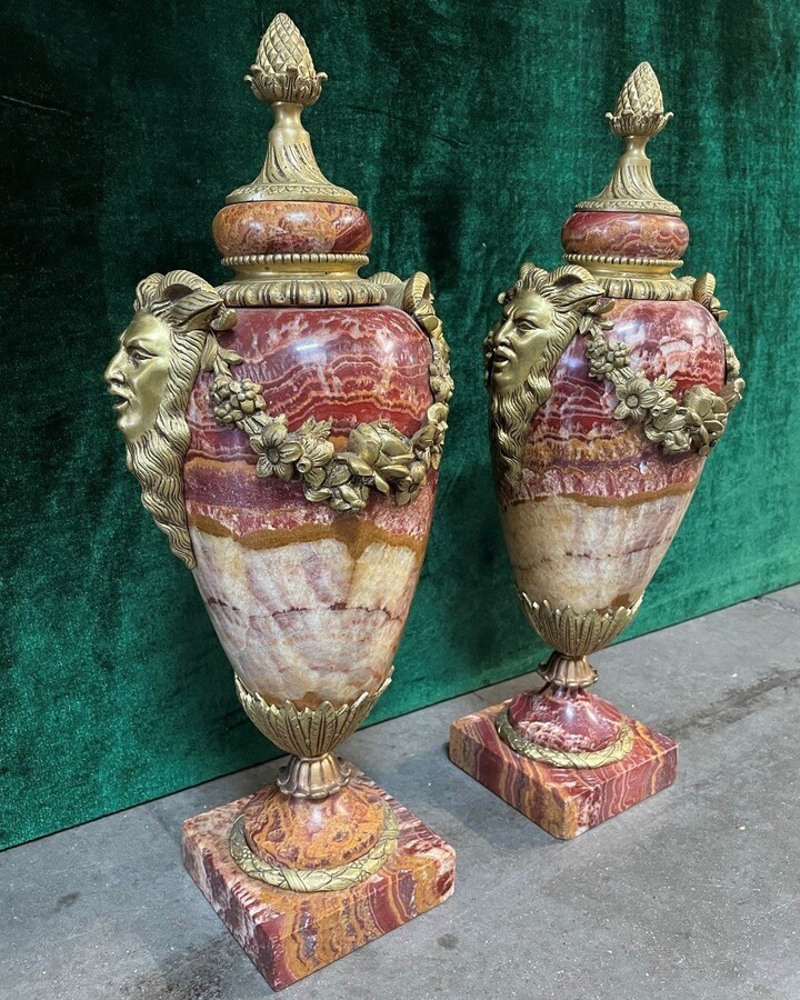 Pair of large marble cassolettes, beautifully coloured 19th century. Very decorative marble cassolettes, decorated with mythological faces and floral gyrations, resting on a marble base with bronze ornaments. Both in very good condition.