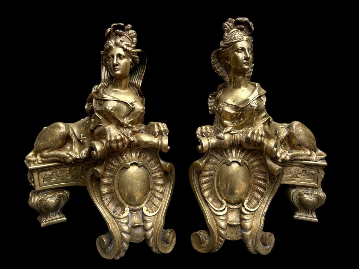 Pair of large Regency bronze ‘Sphinx’ andirons. Beautiful pair of gilt bronze andirons representing sphinxes supported by a coat of arms.Beautiful bronzes, high-quality workmanship, French,
