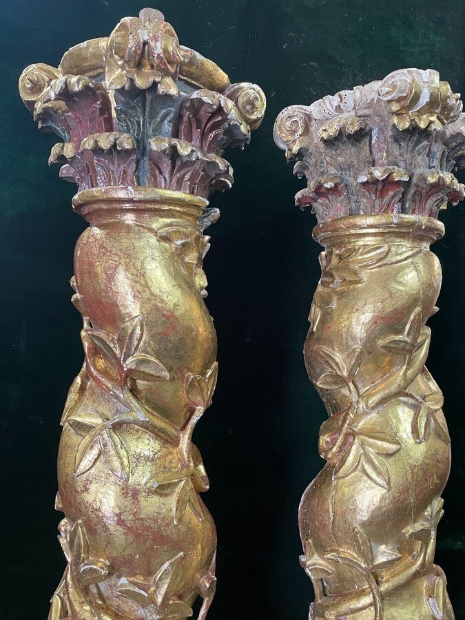 Pair of large twisted columns with capitals early 17th century. Highly decorative gilded wood sculpted columns from the Baroque period in good condition with old traces of woodworm. Dimensions : Height : 191 cm Width : 26 cm Baroque columns from 1650-1680