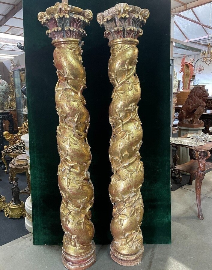 Pair of large twisted columns with capitals early 17th century. Highly decorative gilded wood sculpted columns from the Baroque period in good condition with old traces of woodworm. Dimensions : Height : 191 cm Width : 26 cm Baroque columns from 1650-1680