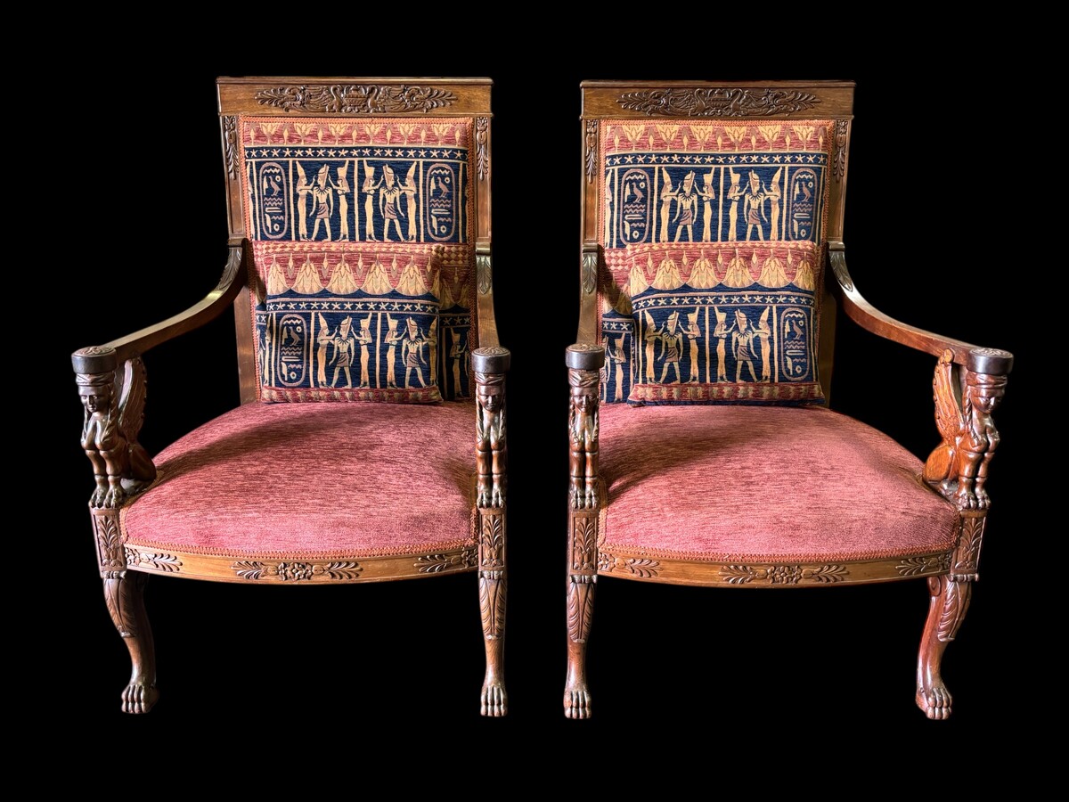 Pair of large walnut armchairs in the 19th century Empire style Armchairs decorated with carved wooden sphinxes and Empire decorations and fitted with a beautiful fabric tapestry and a cushion with Egyptian representations. 