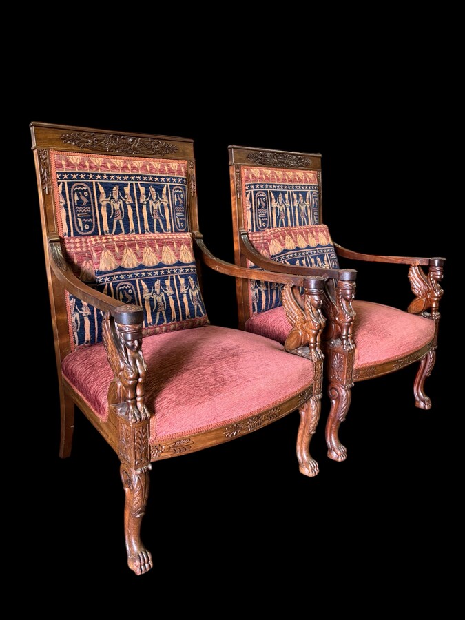 Pair of large walnut armchairs in the 19th century Empire style Armchairs decorated with carved wooden sphinxes and Empire decorations and fitted with a beautiful fabric tapestry and a cushion with Egyptian representations. 