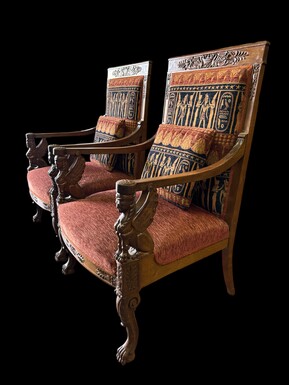 Pair of large walnut armchairs in the 19th century Empire style Armchairs decorated with carved wooden sphinxes and Empire decorations and fitted with a beautiful fabric tapestry and a cushion with Egyptian representations. 