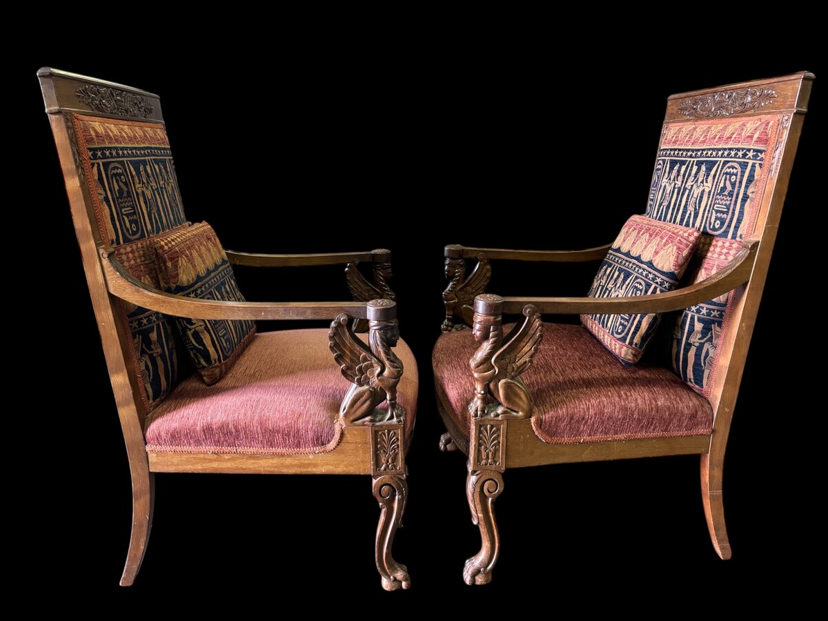 Pair of large walnut armchairs in the 19th century Empire style Armchairs decorated with carved wooden sphinxes and Empire decorations and fitted with a beautiful fabric tapestry and a cushion with Egyptian representations. 