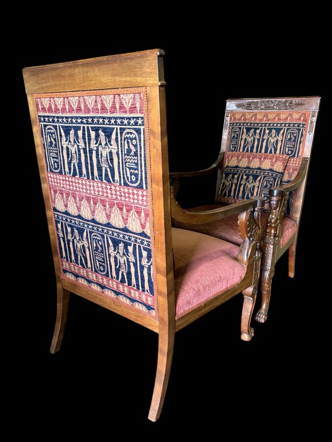 Pair of large walnut armchairs in the 19th century Empire style Armchairs decorated with carved wooden sphinxes and Empire decorations and fitted with a beautiful fabric tapestry and a cushion with Egyptian representations. 