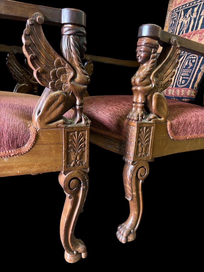 Pair of large walnut armchairs in the 19th century Empire style Armchairs decorated with carved wooden sphinxes and Empire decorations and fitted with a beautiful fabric tapestry and a cushion with Egyptian representations. 
