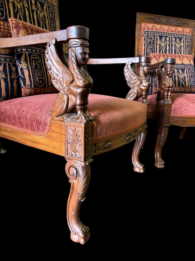 Pair of large walnut armchairs in the 19th century Empire style Armchairs decorated with carved wooden sphinxes and Empire decorations and fitted with a beautiful fabric tapestry and a cushion with Egyptian representations. 
