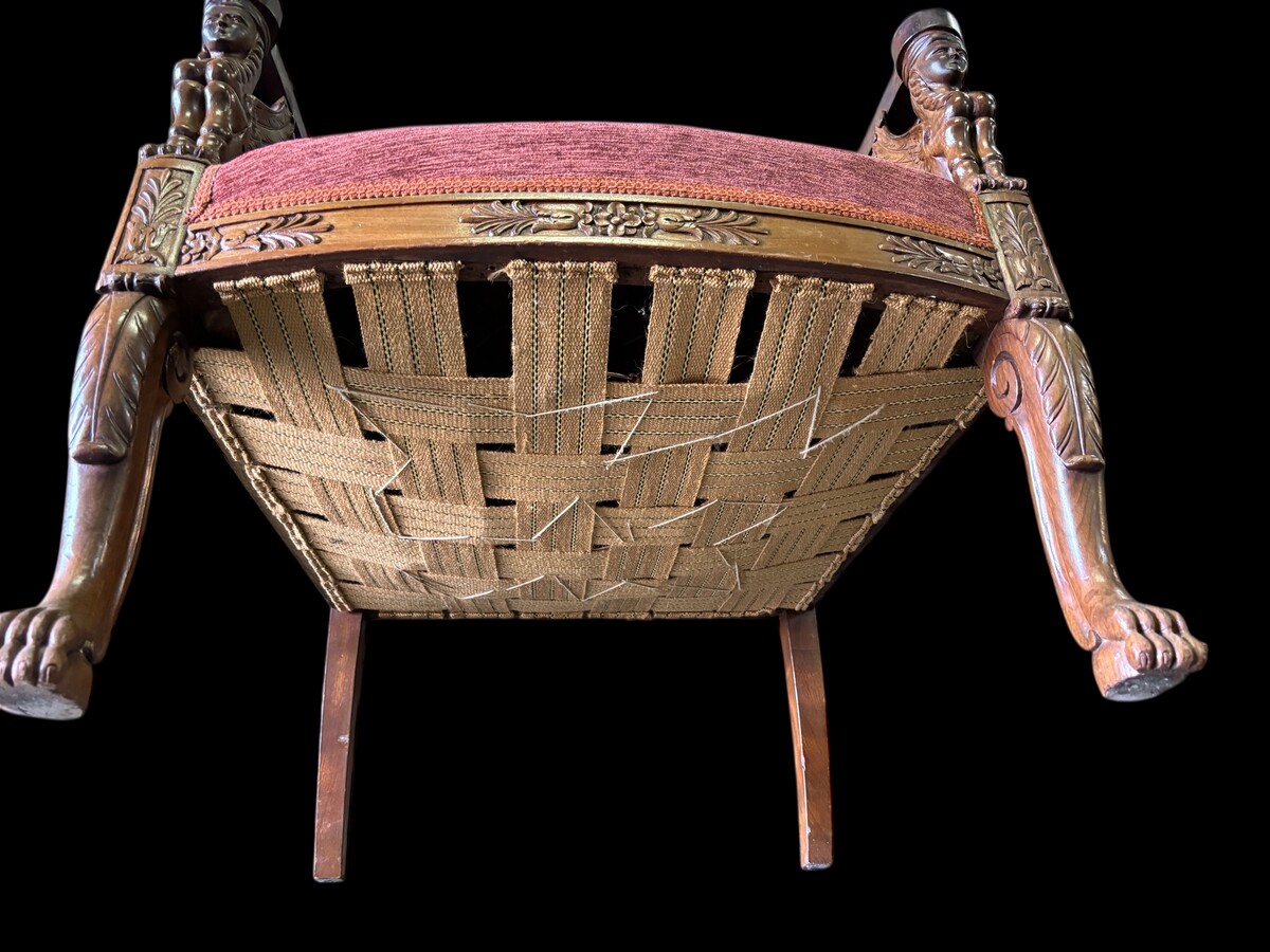 Pair of large walnut armchairs in the 19th century Empire style Armchairs decorated with carved wooden sphinxes and Empire decorations and fitted with a beautiful fabric tapestry and a cushion with Egyptian representations. 