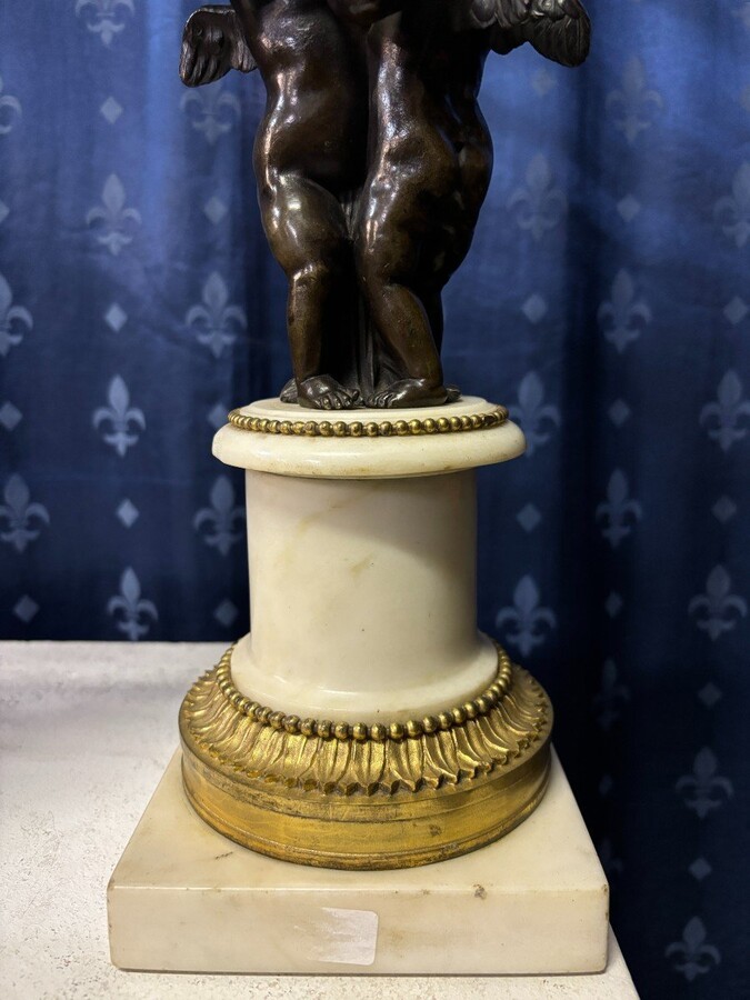 Pair of Napoleon III ‘2 angels’ bronze candelabras. Nice 19thC. candelabra representing a pair of angels carrying 3 gilt bronze candelabra with sprigs of flowers resting on a white marble base.