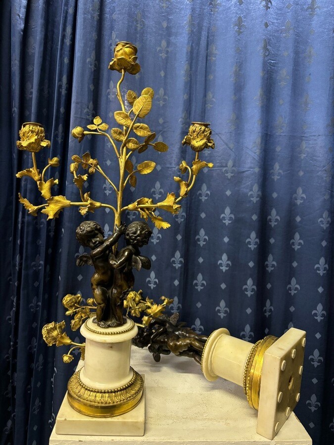 Pair of Napoleon III ‘2 angels’ bronze candelabras. Nice 19thC. candelabra representing a pair of angels carrying 3 gilt bronze candelabra with sprigs of flowers resting on a white marble base.