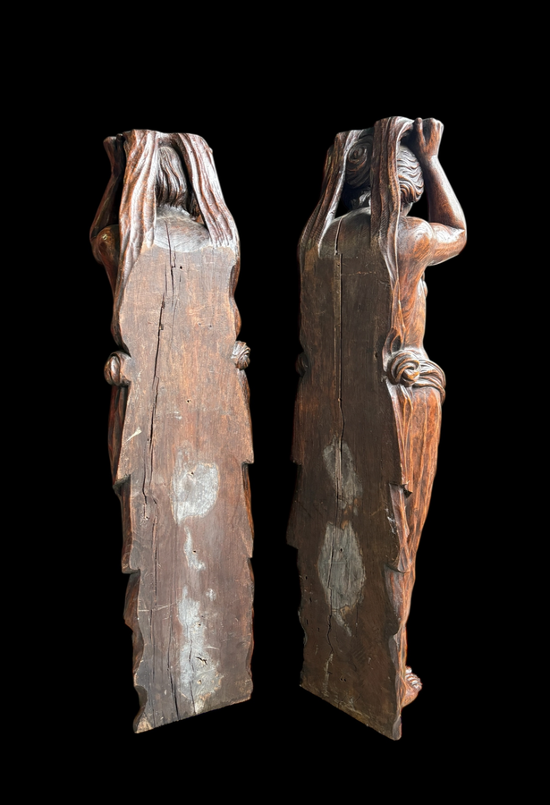 Pair of Renaissance-style sculptures/caryatids in oak, early 19thC. Beautifully carved decorative wooden sculptures representing a female figure and a male figure dressed in robes. Dimensions: Height: 123 cm Width: 31 cm Depth: 28/29 cm In good condition,