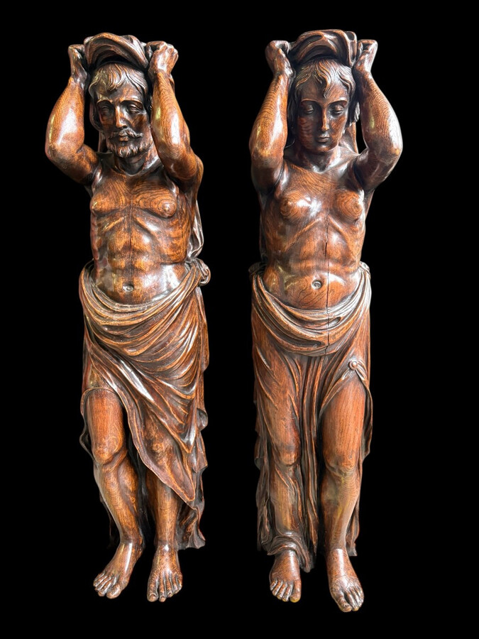 Pair of Renaissance-style sculptures/caryatids in oak, early 19thC. Beautifully carved decorative wooden sculptures representing a female figure and a male figure dressed in robes. Dimensions: Height: 123 cm Width: 31 cm Depth: 28/29 cm In good condition,