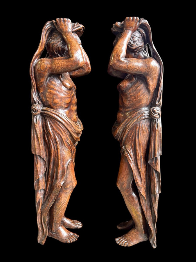 Pair of Renaissance-style sculptures/caryatids in oak, early 19thC. Beautifully carved decorative wooden sculptures representing a female figure and a male figure dressed in robes. Dimensions: Height: 123 cm Width: 31 cm Depth: 28/29 cm In good condition,