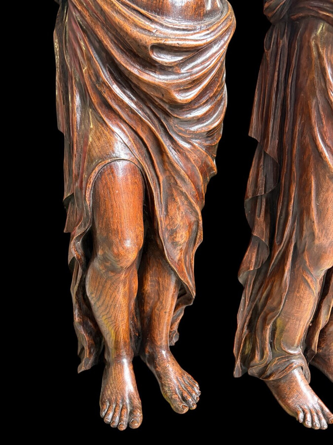 Pair of Renaissance-style sculptures/caryatids in oak, early 19thC. Beautifully carved decorative wooden sculptures representing a female figure and a male figure dressed in robes. Dimensions: Height: 123 cm Width: 31 cm Depth: 28/29 cm In good condition,