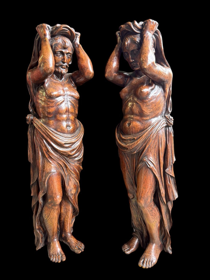 Pair of Renaissance-style sculptures/caryatids in oak, early 19thC. Beautifully carved decorative wooden sculptures representing a female figure and a male figure dressed in robes. Dimensions: Height: 123 cm Width: 31 cm Depth: 28/29 cm In good condition,