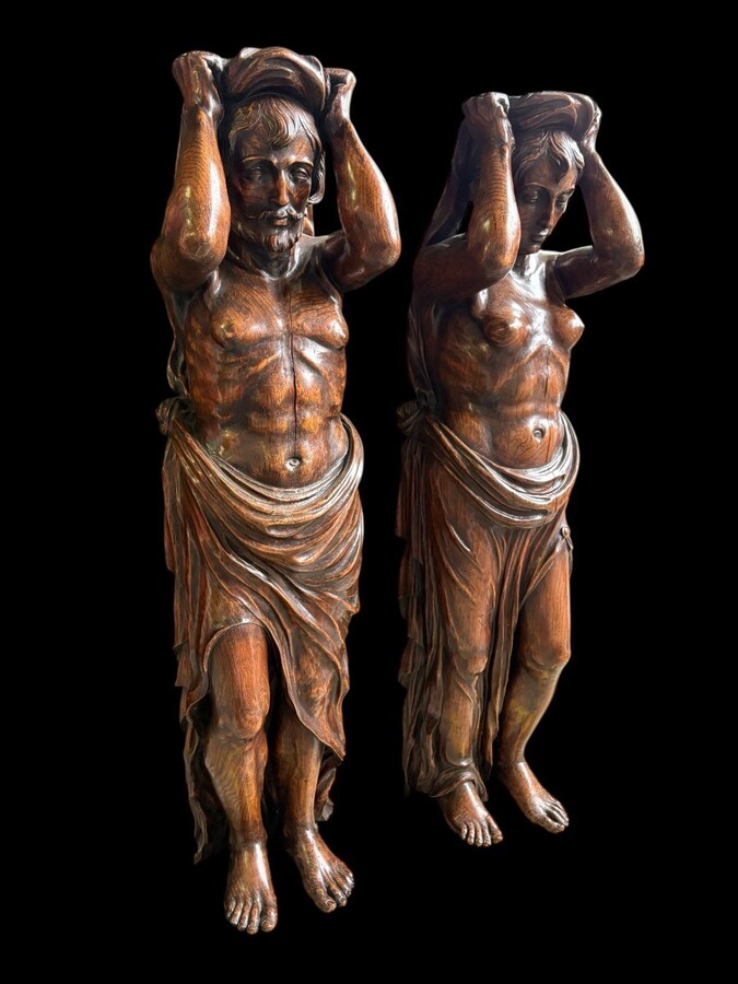 Pair of Renaissance-style sculptures/caryatids in oak, early 19thC. Beautifully carved decorative wooden sculptures representing a female figure and a male figure dressed in robes. Dimensions: Height: 123 cm Width: 31 cm Depth: 28/29 cm In good condition
