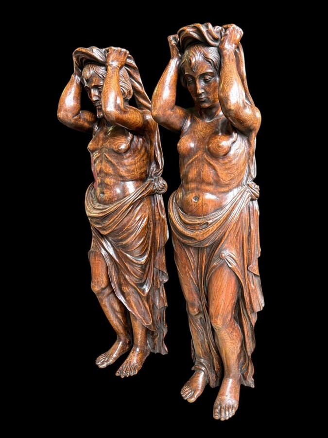 Pair of Renaissance-style sculptures/caryatids in oak, early 19thC. Beautifully carved decorative wooden sculptures representing a female figure and a male figure dressed in robes. Dimensions: Height: 123 cm Width: 31 cm Depth: 28/29 cm In good condition