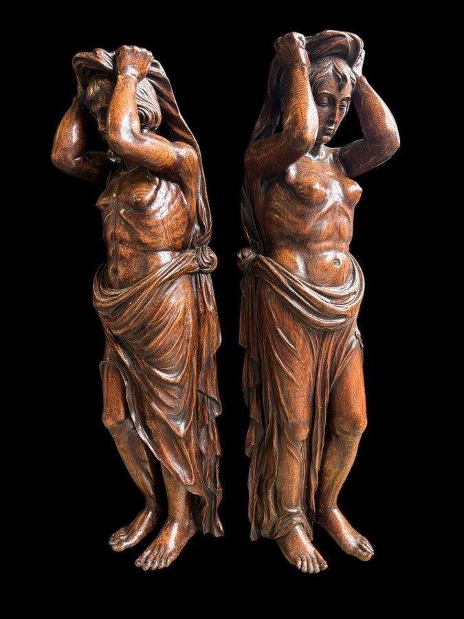 Pair of Renaissance-style sculptures/caryatids in oak, early 19thC. Beautifully carved decorative wooden sculptures representing a female figure and a male figure dressed in robes. Dimensions: Height: 123 cm Width: 31 cm Depth: 28/29 cm In good condition