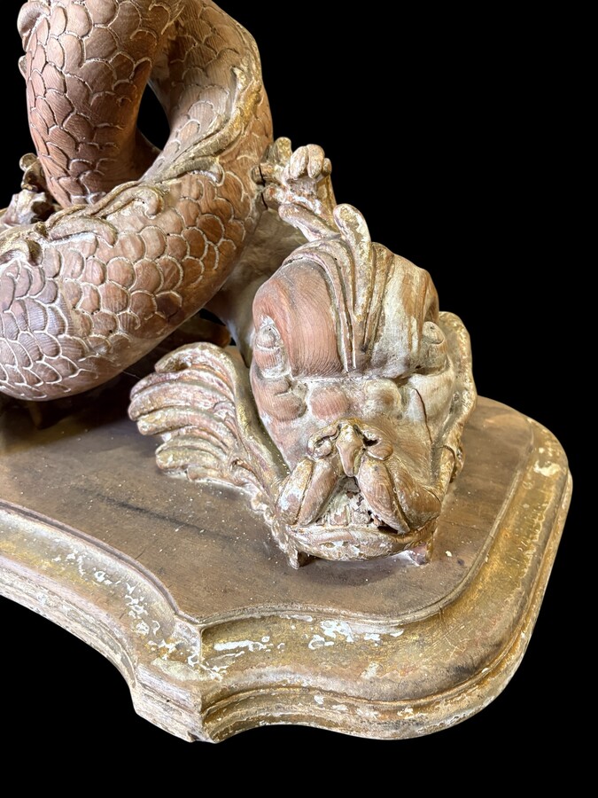 Pair of wooden coffee tables, ‘Mythological Fish,’ late 19th century. Highly decorative coffee tables depicting two intertwined fish, finely carved and featuring a round glass top.In good condition