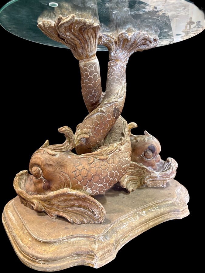 Pair of wooden coffee tables, ‘Mythological Fish,’ late 19th century. Highly decorative coffee tables depicting two intertwined fish, finely carved and featuring a round glass top.In good condition
