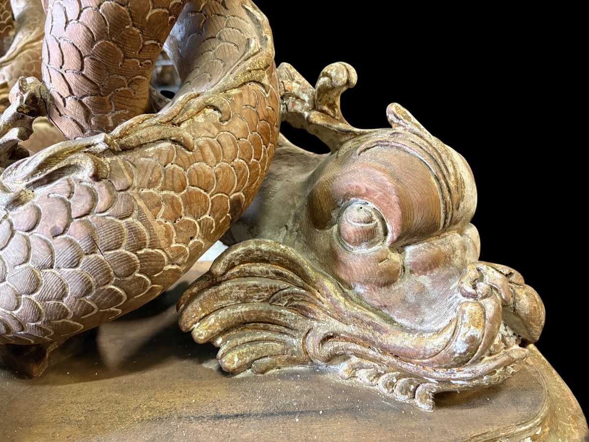 Pair of wooden coffee tables, ‘Mythological Fish,’ late 19th century. Highly decorative coffee tables depicting two intertwined fish, finely carved and featuring a round glass top.In good condition