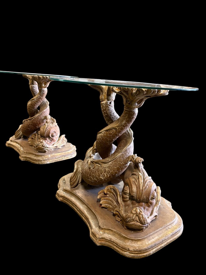 Pair of wooden coffee tables, ‘Mythological Fish,’ late 19th century. Highly decorative coffee tables depicting two intertwined fish, finely carved and featuring a round glass top.In good condition